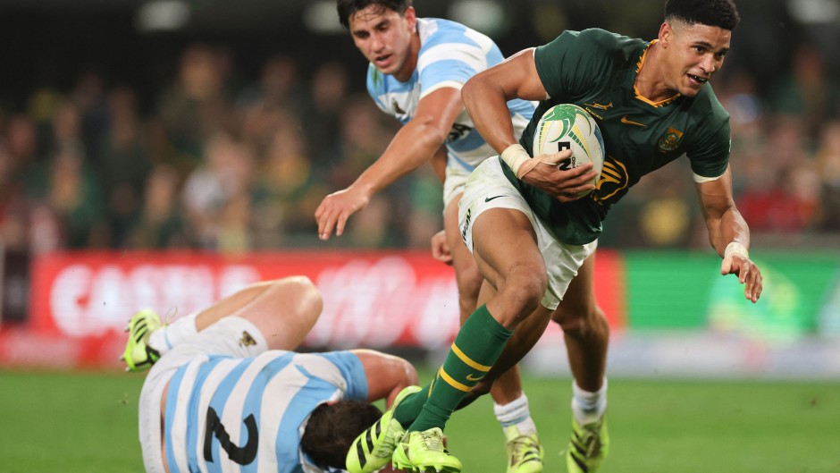 South Africa's fly-half Sacha Feinberg-Mngomezulu (R) runs with the ball to score a try during the Rugby Championship Test match between South Africa and Argentina at Kings Park Stadium in Durban on September 27, 2025.