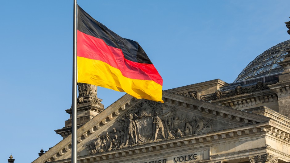 The German flag fluttering in front of Reichstag building. GettyImages/arsenisspyros