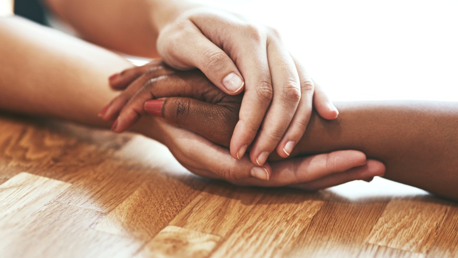 hands held together across a table