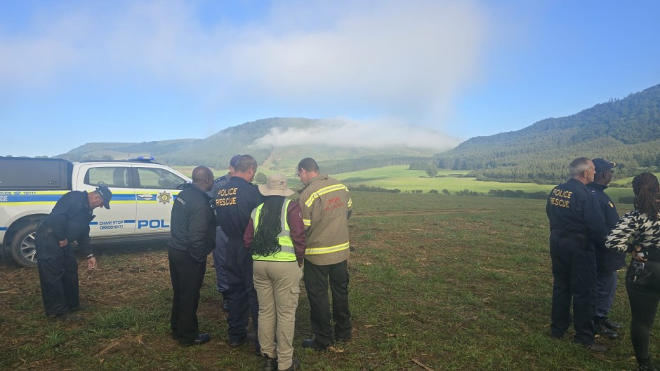 Search teams on the ground near the plane crash. Supplied