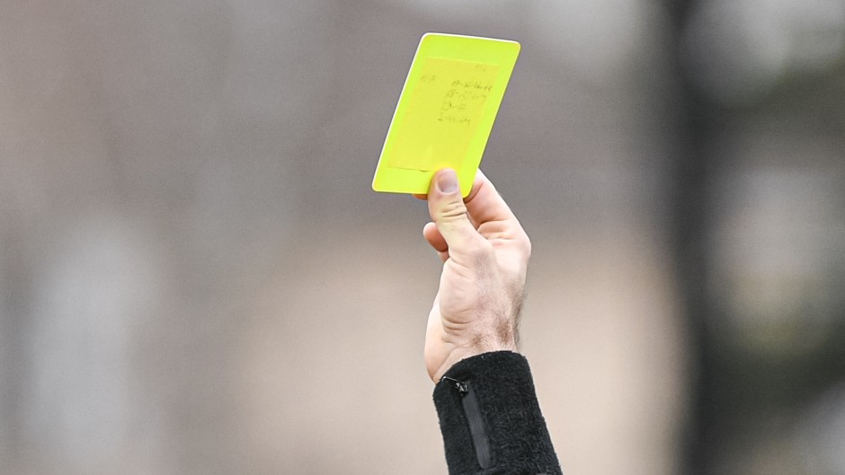 File: A referee's hand with a yellow card. Victor Joly/DPPI via AFP