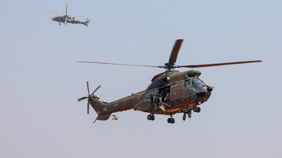 File: A Denel Aeronautics Atlas "Oryx" utility helicopter and a Denel “Rooivalk” (L) attack helicopter. AFP/Phill Magakoe