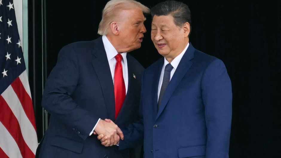 US President Donald Trump (L) and China's President Xi Jinping shake hands as they leave after their talks at the Gimhae Air Base. Photo by Andrew Caballero-Reynolds/ AFP 