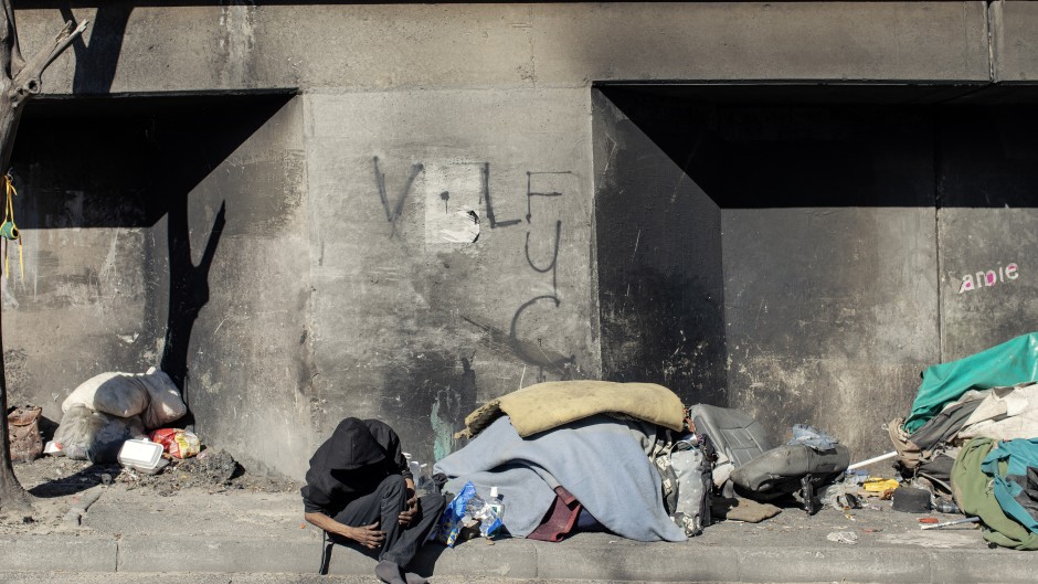 File: A homeless man sleeping under an underpass. AFP/Gianluigi Guercia