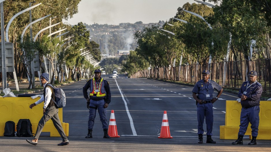 SAPS officers monitor the area near the Nasrec Expo Centre in Johannesburg. AFP/Marco Longari