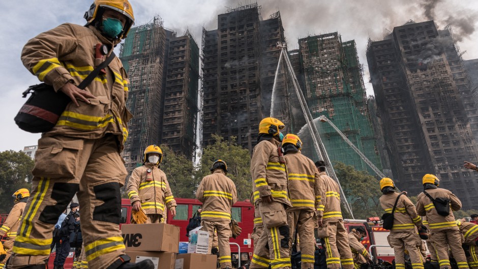 Hong Kong firefighters scouring the apartment complex after the blaze tore through the high-rises. AFP/Dale De La Rey