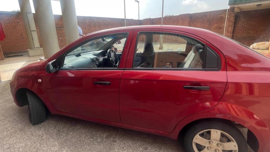 A red Chevrolet Aveo sedan belonging to Brown Mogotsi