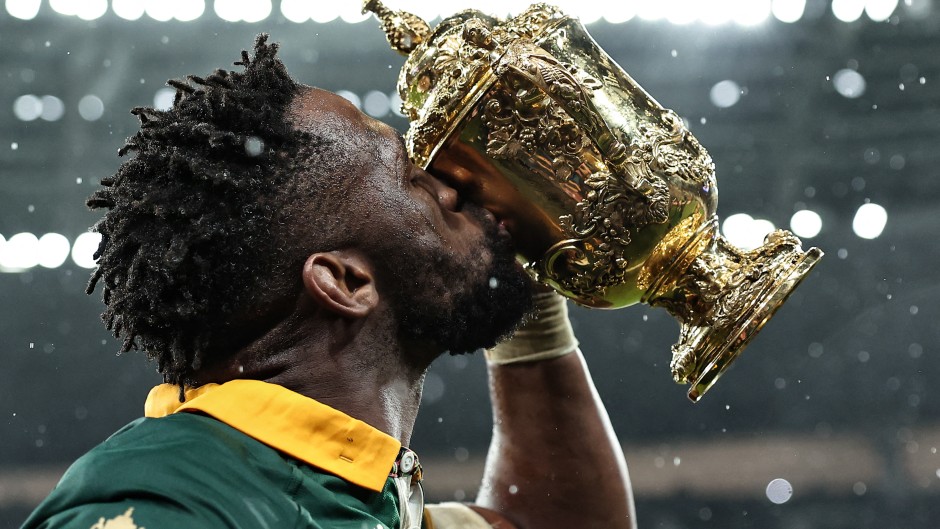 Siya Kolisi (C) kisses the Webb Ellis Cup