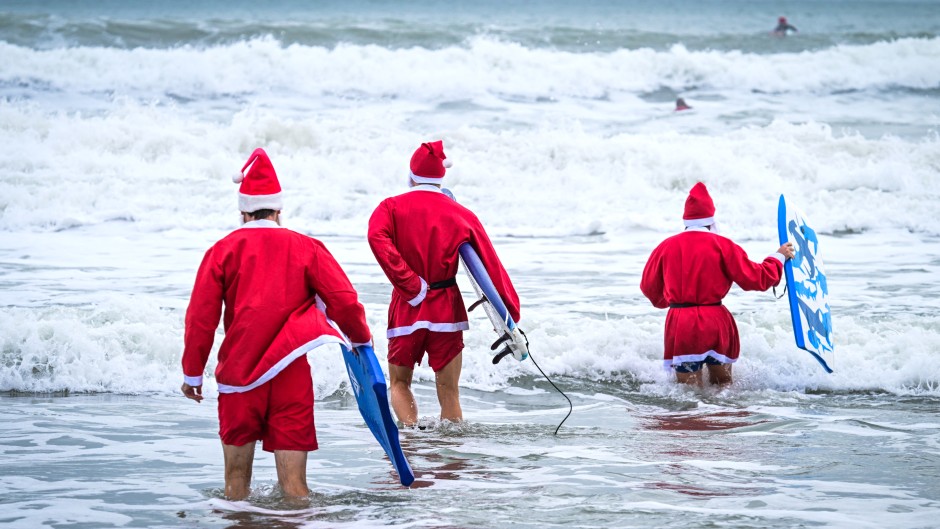 Surfers dressed as Santa Claus. AFP/Giorgio Viera