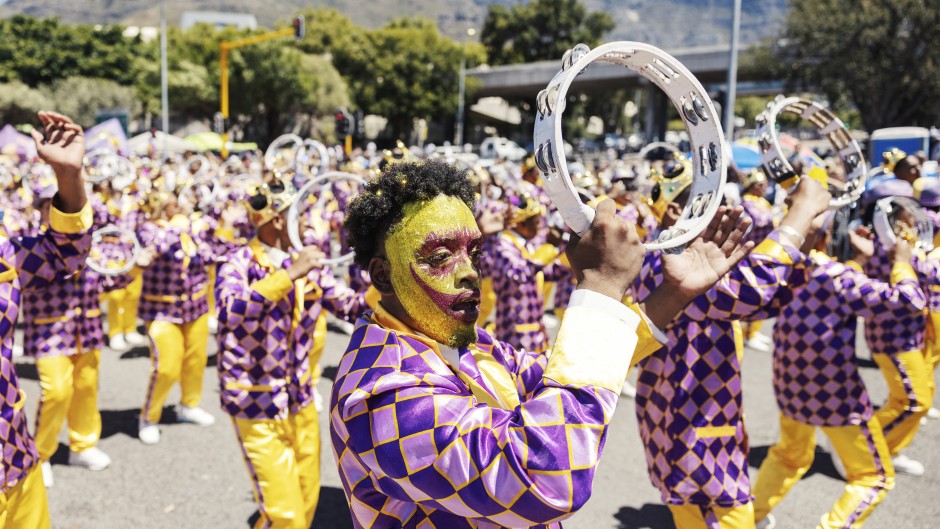 A Kaapse Klopse minstrel dances as his troupe moves forward during the annual Kaapse Klopse parade. AFP/Gianluigi Guercia