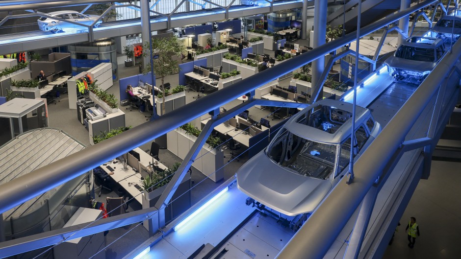 File: Body shells drive through the BMW Group plant in Leipzig. Jan Woitas/dpa via AFP