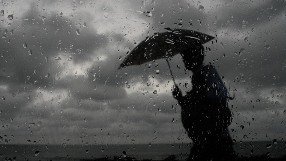 File: A man with an umbrella walking in the rain. Thilina Kaluthotage/NurPhoto via AFP