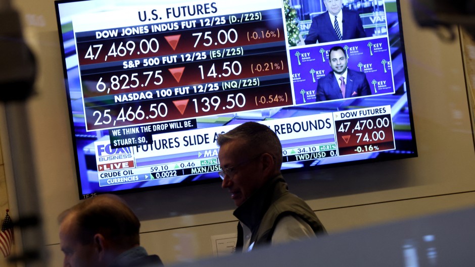 A television displaying market statistics is displayed as traders work on the floor of the NYSE. AFP/Timothy A Clary