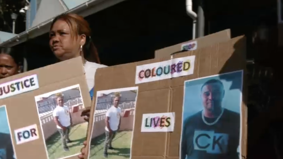 Community members protesting outside court.