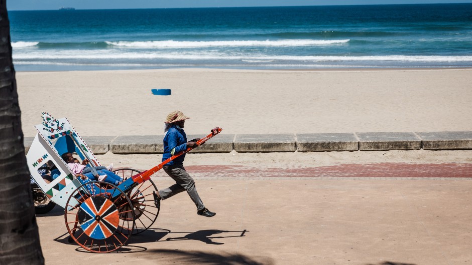 File: A rickshaw puller goes about his business with tourists on a ride at the North Beach. AFP/Rajesh Jantilal