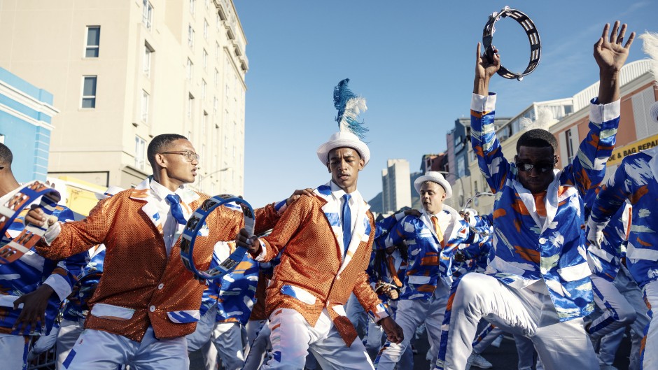File: Kaapse Klopse minstrels dance as their troupe moves forward during the annual Kaapse Klopse parade. AFP/Gianluigi Guercia