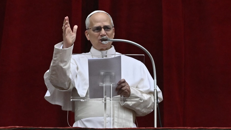 Pope Leo XIV addresses the crowd from the central balcony of St Peter's Basilica. AFP/Filippo Monteforte