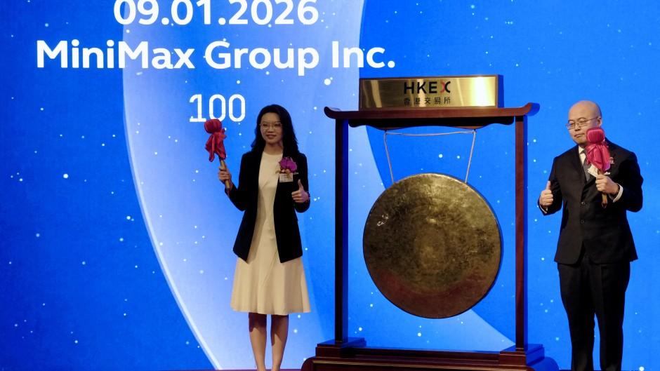 Shanghai-based AI startup MiniMax's CEO Yan Junjie (R) and Co-founder and COO Yun Yeyi (L) attend the firm's listing ceremony at the Hong Kong stock exchange. AFP/Tommy Wang