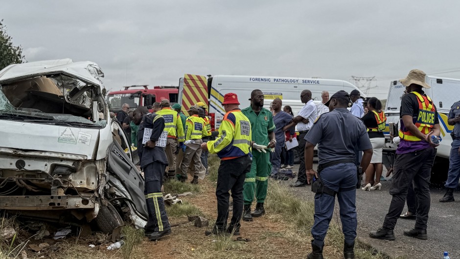Rescue workers stand at the scene of the Vanderbijlpark accident. AFP/John Mkhize
