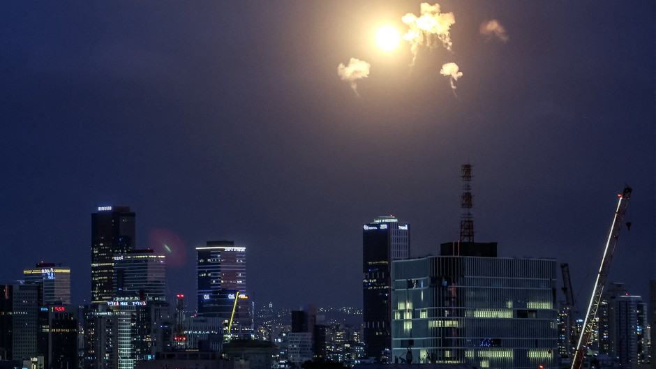 Explosions from projectile interceptions by Israel's Iron Dome missile defence system are pictured over Tel Aviv. AFP/Jack Guez