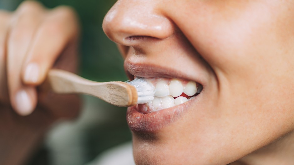 A woman brushing teeth with toothpaste. Microgen Images/Science Photo Library via AFP