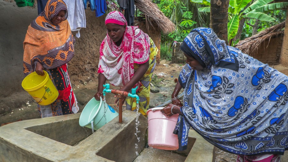 Women with buckets getting tap water. Emmanuel Herman/Xinhua via AFP