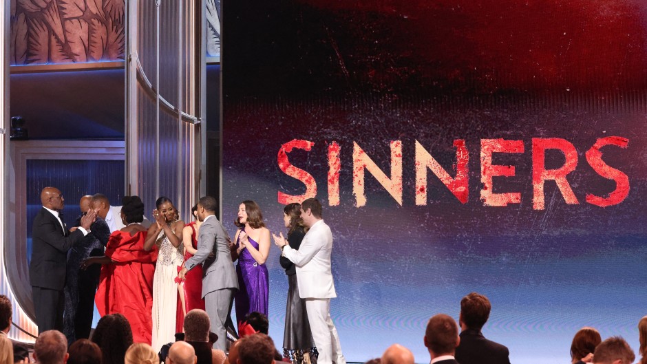 The cast of "Sinners" arrive onstage to accept the award for Outstanding Performance by a Cast in a Motion Picture. AFP/Valerie Macon