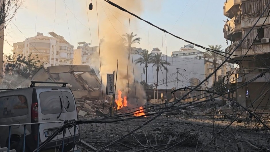 Smoke billowing from a fire and buildings damaged after an early morning Israeli strike on Beirut's southern suburbs. AFPTV/STR