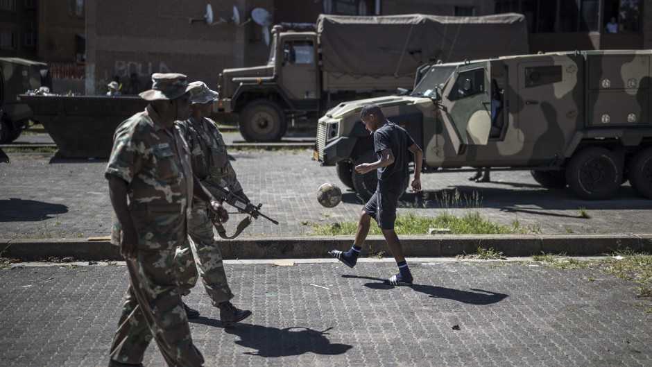  soldiers patrol a residential complex in Westbury, Johannesburg. AFP/Marco Longari