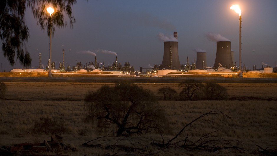A Sasol coal-to-liquid fuel plant stands at dusk on July 7, 2008 in Secunda, South Africa