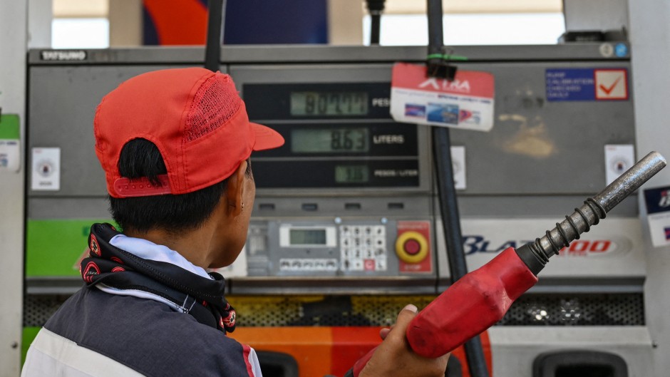 A man refuels the tank of a motorcycle at a petrol station in Manila. AFP/Jam Sta Rosa
