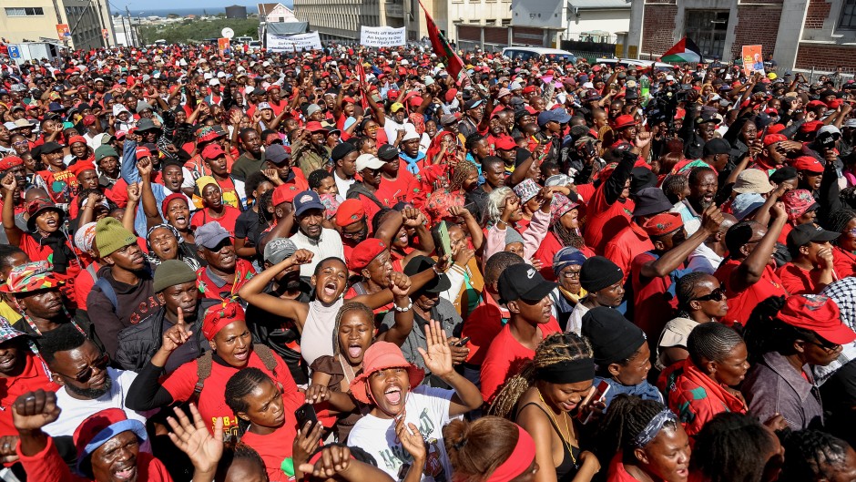 Supporters of Economic Freedom Fighters (EFF) leader Julius Malema listen to his speech outside the KuGompo City Regional court in East London on April 15, 2026 following his sentencing for firing an assault rifle at a rally eight years ago.