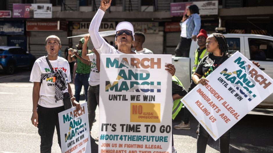 Protesters chant slogans and hold placards at a protest march against undocumented migrants. AFP/Emmanuel Croset