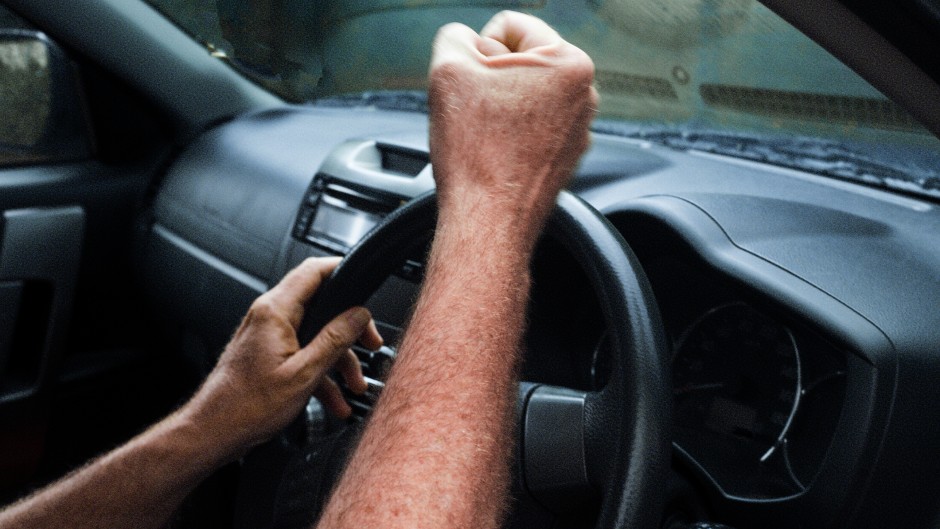 File: An angry car driver pulls a fist at another motorist. GettyImages/brazzo