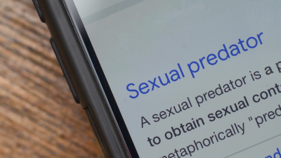 The words 'sexual predator' seen on a phone. GettyImages/Abu Hanifah