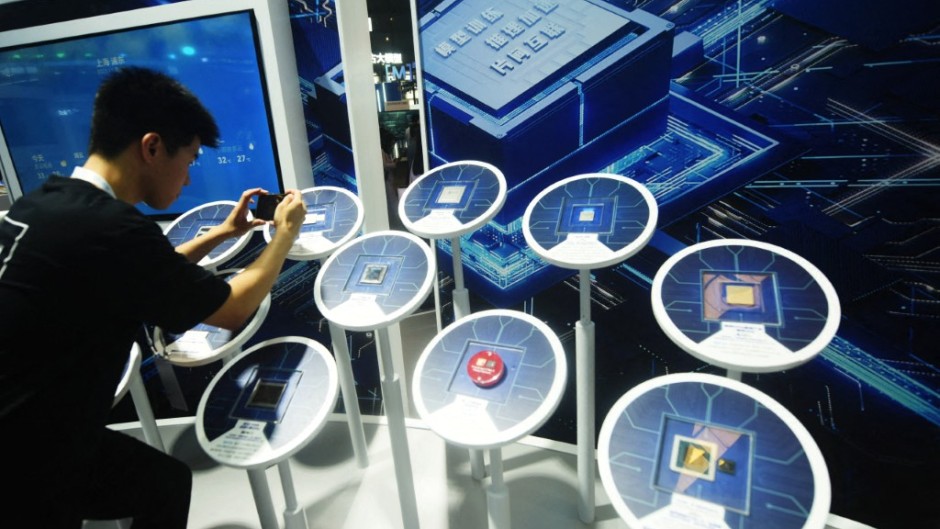 File: A visitor looking at domestic and foreign artificial intelligence chips. CFOTO/NurPhoto via AFP