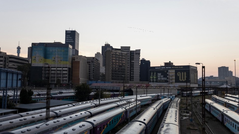 A general view of Shosholoza Meyl train carriages with the skyline of Braamfontein, Johannesburg, in the background on March 28, 2026. (Photo by Wikus de Wet / AFP)