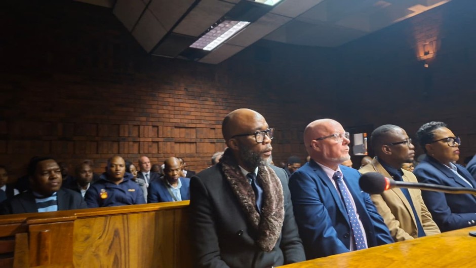 Vusimuzi 'Cat' Matlala in court, behind him is suspended SAPS National Commissioner General Fannie Masemola.