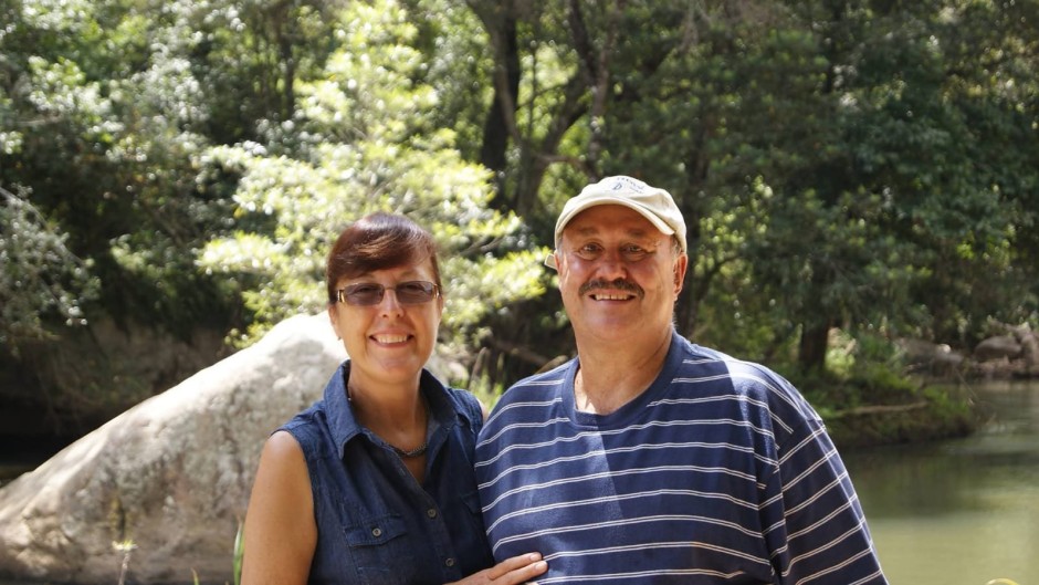 Couple standing next to each other against a park backdrop