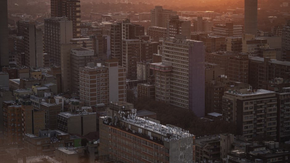 A general view of high-rise buildings of the Johannesburg skyline from the 51th floor of Ponte City, also known as Ponte Tower, in Berea, Johannesburg on May 24, 2024. (Photo by Michele Spatari / AFP)
