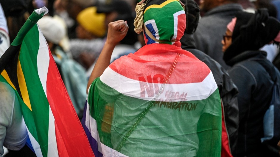 Protesters chant slogans as they march during a demonstration by the "March and March" and Operation Dudula movements. AFP/Rodger Bosch