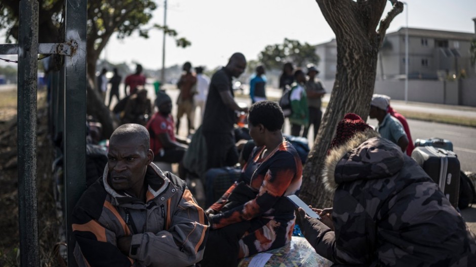 Malawian undocumented migrants sit in a shaded area in Durban. AFP/Marco Longari