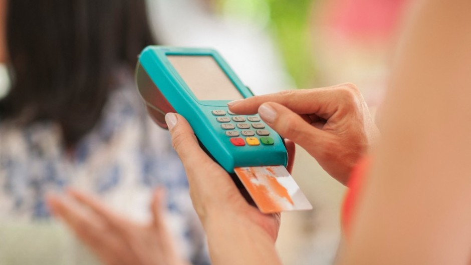 File: A person paying a trader with a credit card. Zero Creatives/Connect Images via AFP