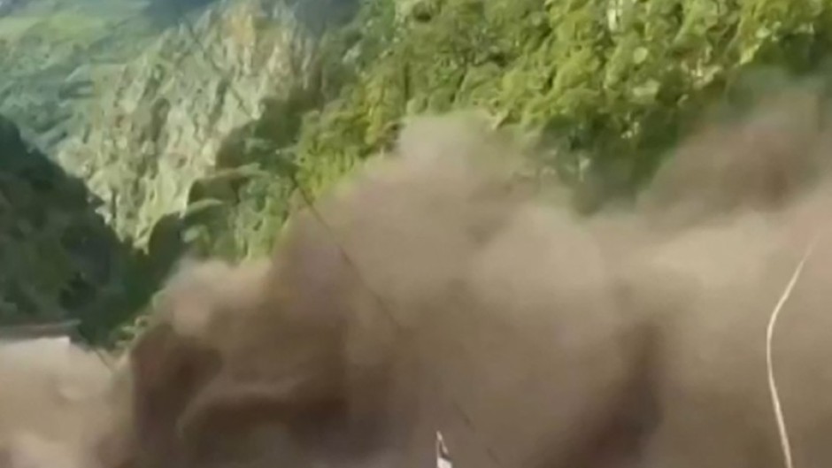 This frame grab from a UGC footage courtesy of Nepal Police shows floodwaters sweeping through houses along the Bhote Koshi River after flash floods in Rasuwa district on August 26, 2026.  Photo by-UGC / NEPAL POLICE / AFP
