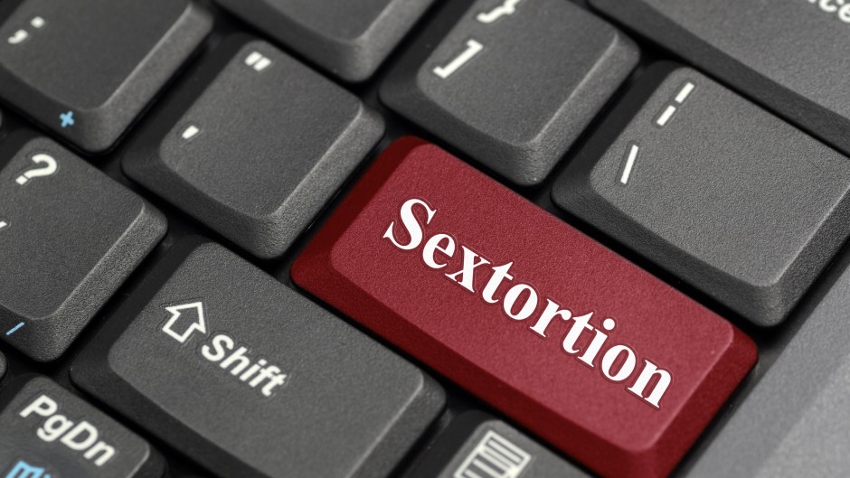 The word sextortion on a keyboard. GettyImages/payphoto