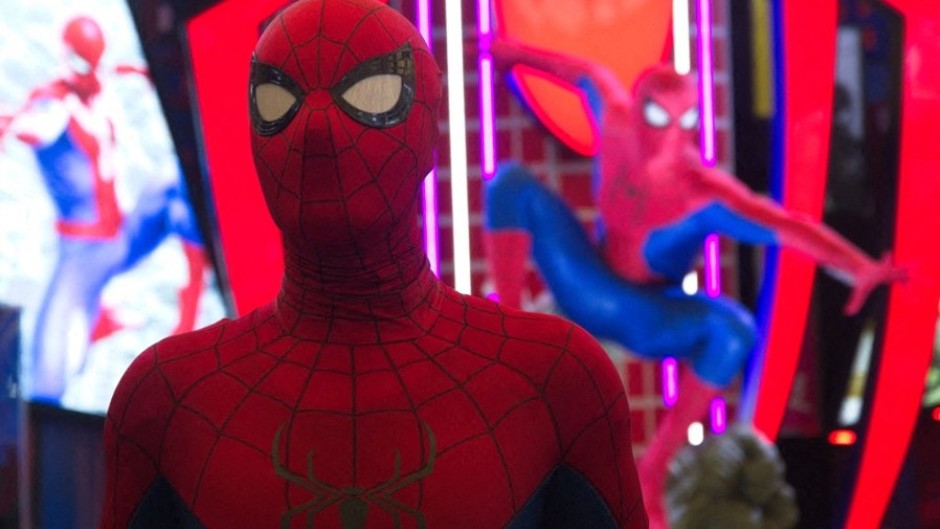 A man dressed as Spider-Man poses in front of a Marvel Studios Spider-Man booth. Ying Tang/NurPhoto via AFP