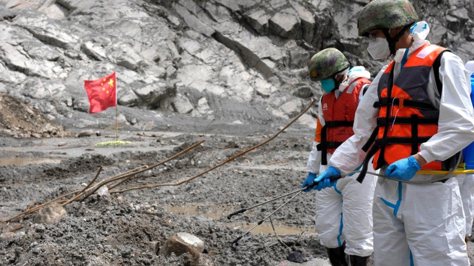 An epidemic prevention team disinfects the search area around the destroyed Gyirong Port in Gyirong County. AFP/CNS/China Out