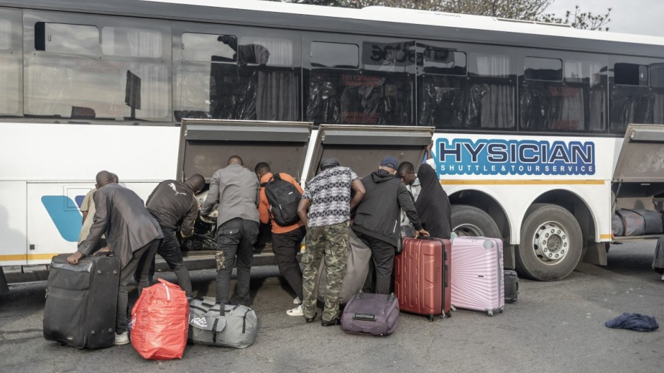 Documented foreign nationals pack their belonging in a bus in Durban for relocation to the Lindela Repatriation Centre in Gauteng. AFP/Rajesh Jantilal