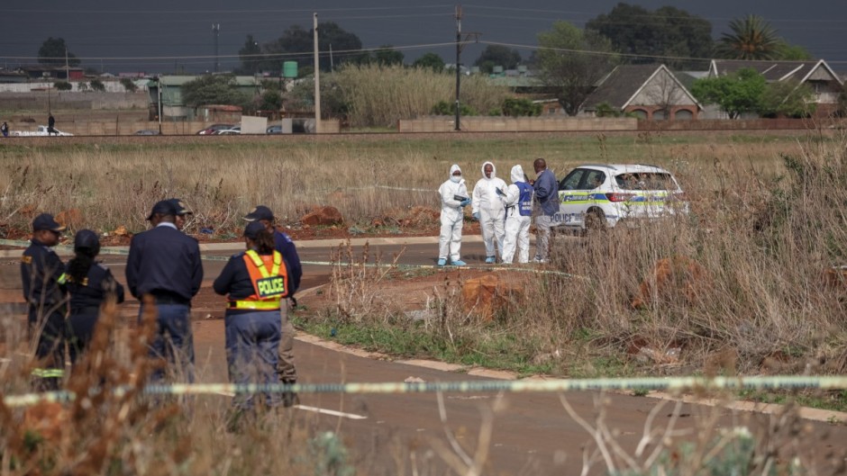 Members of the South African Police Service (SAPS) Forensic Pathology Services work on the crime scene where the body of a woman was discovered in Boksburg on September 17, 2026.