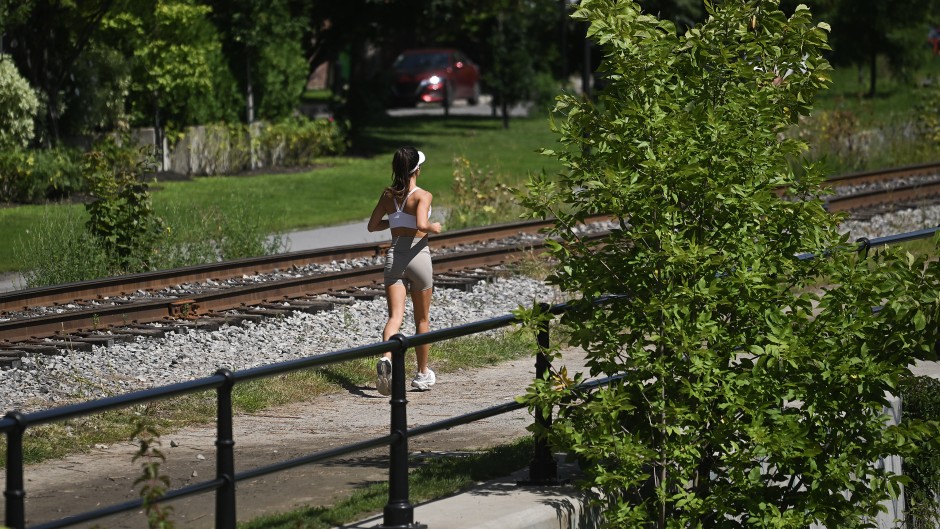 A woman jogs along a canal in Montreal, Quebec, Canada, on August 21, 2026. (Photo by Graham Hughes/NurPhoto via Getty Images)